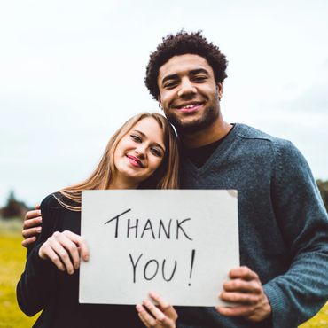 Volunteers holding thank you sign