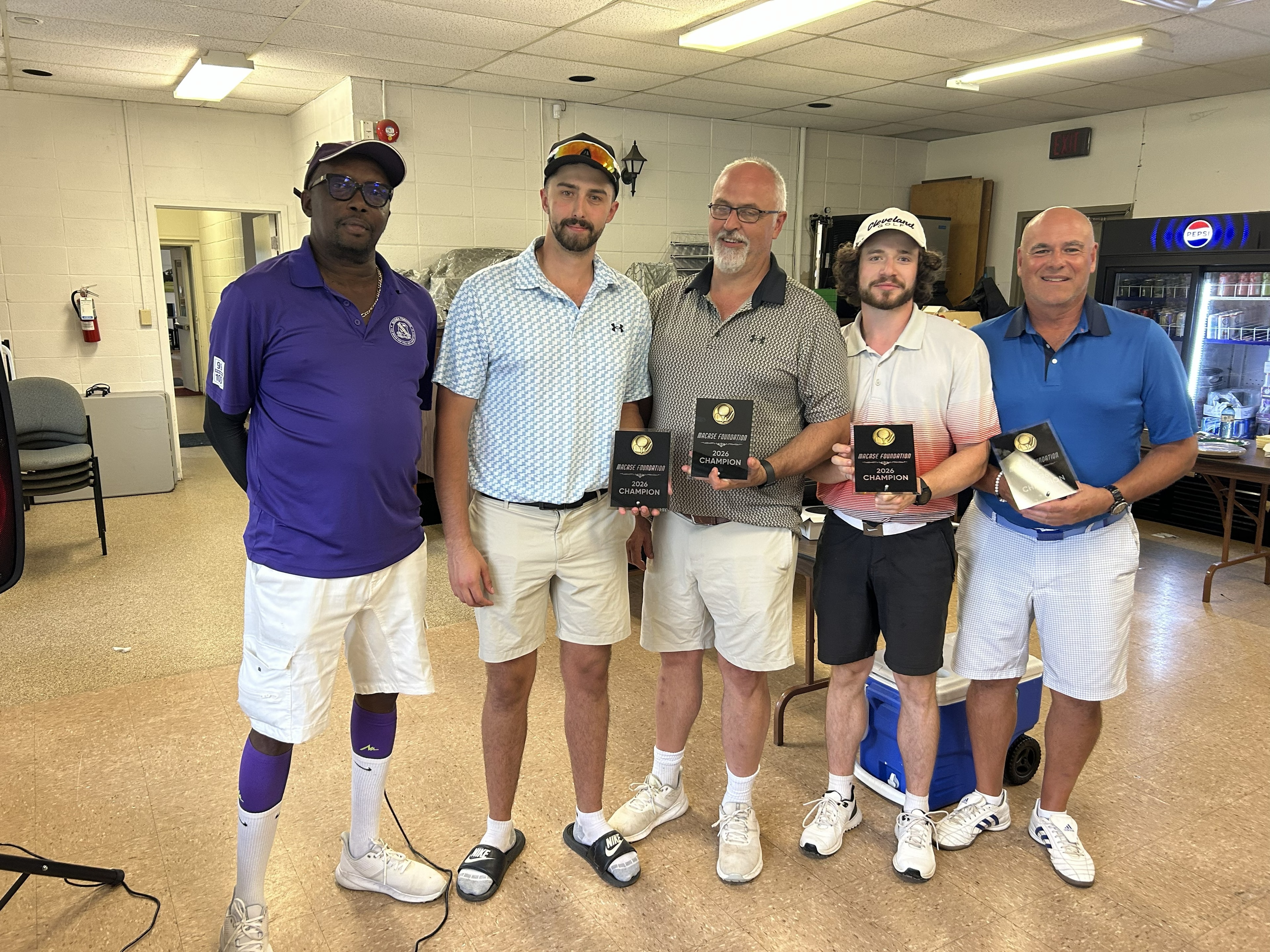 Tournament winners holding MACASE Foundation 2026 Champion plaques